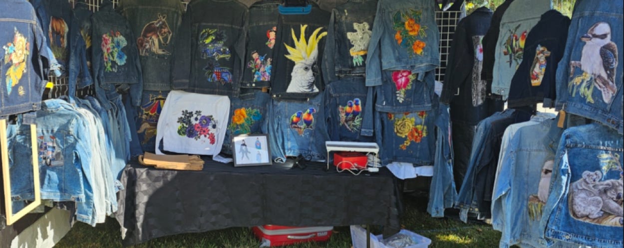 Stylish person in casual outfit posing with a vintage car on a rainy day.